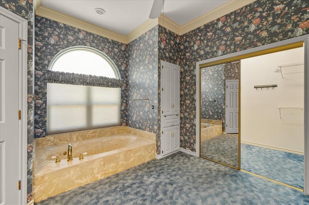 9 Willow Ridge Road Greenville, TX 75402 - Photo 16 of 31 Full bathroom with crown molding, a bath, wallpapered walls, and a ceiling fan