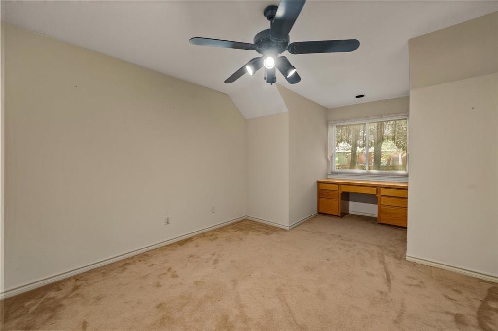 9 Willow Ridge Road Greenville, TX 75402 - Photo 19 of 31 Unfurnished bedroom featuring light colored carpet, a ceiling fan, and built in desk