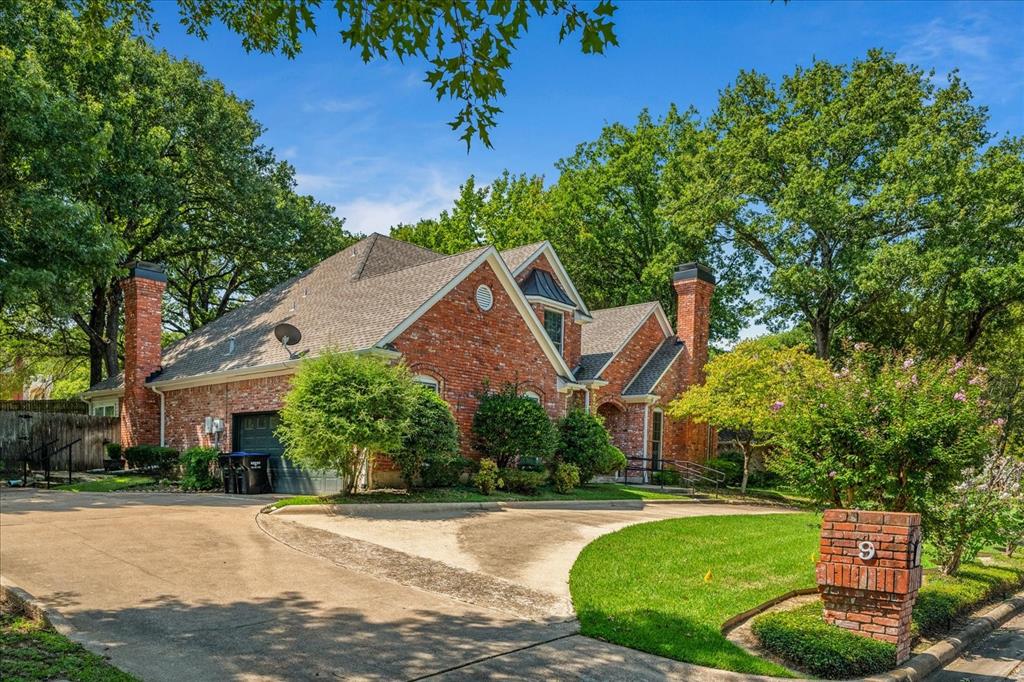 9 Willow Ridge Road Greenville, TX 75402 - Photo 2 of 31 View of front facade with a chimney, driveway, brick siding, a garage, and a shingled roof