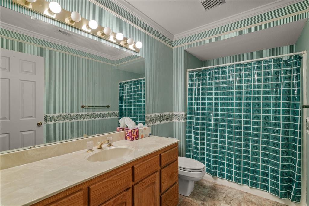 9 Willow Ridge Road Greenville, TX 75402 - Photo 20 of 31 Full bathroom with vanity, curtained shower, and ornamental molding
