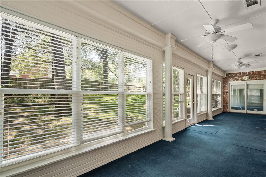 9 Willow Ridge Road Greenville, TX 75402 - Photo 24 of 31 Unfurnished sunroom featuring carpet floors and brick wall