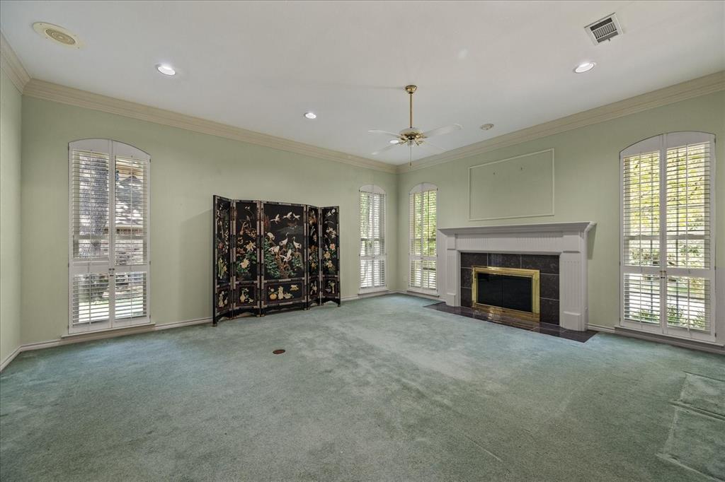 9 Willow Ridge Road Greenville, TX 75402 - Photo 6 of 31 Unfurnished living room featuring crown molding, plenty of natural light, carpet, a ceiling fan, and recessed lighting
