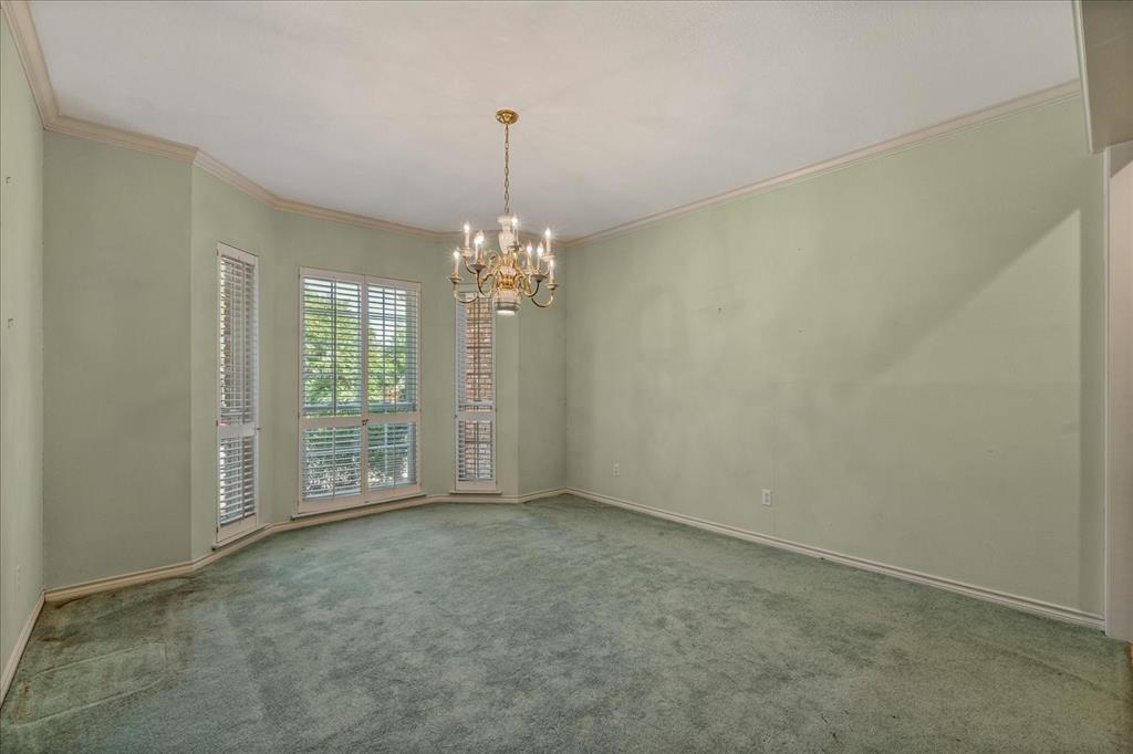 9 Willow Ridge Road Greenville, TX 75402 - Photo 7 of 31 Unfurnished dining area featuring crown molding, carpet flooring, and a chandelier
