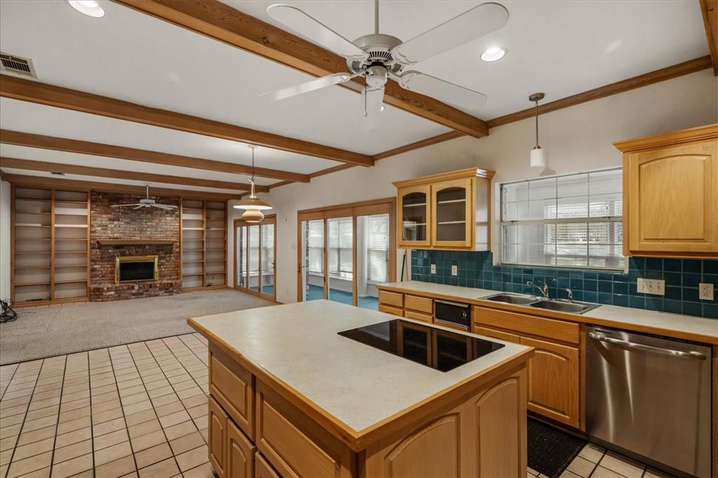 9 Willow Ridge Road Greenville, TX 75402 - Photo 8 of 31 Kitchen featuring a ceiling fan, hanging light fixtures, dishwasher, light tile patterned floors, and a brick fireplace