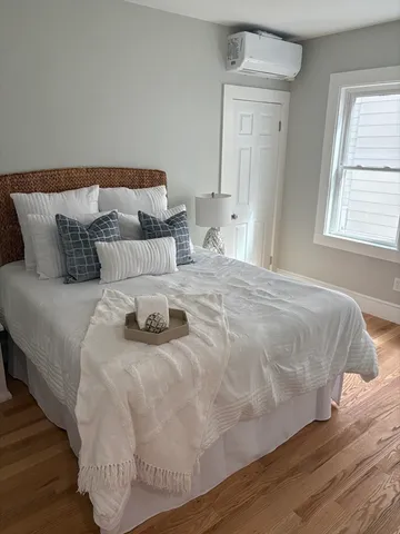 a bedroom with a bed and window