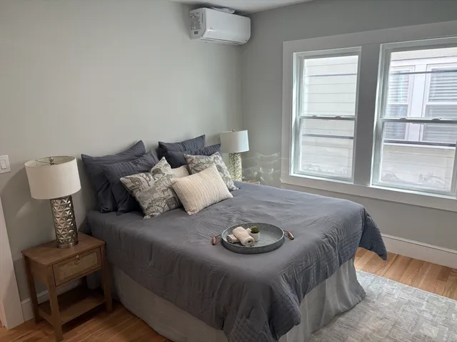 a bed sitting in a bedroom next to a window