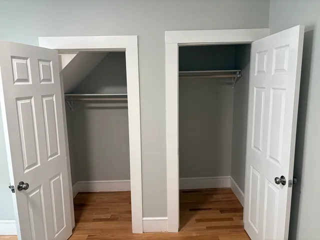 a view of a hallway with wooden floor and entryway