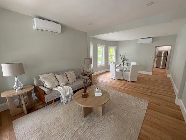 a living room with furniture a window and a table