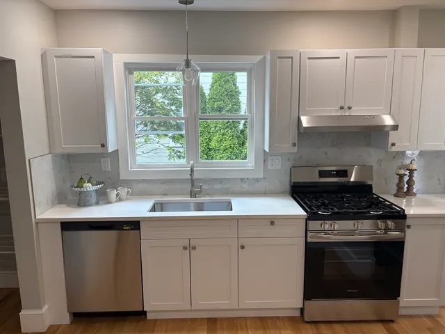 a kitchen with appliances cabinets and a sink