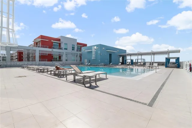 a swimming pool with outdoor seating and city view