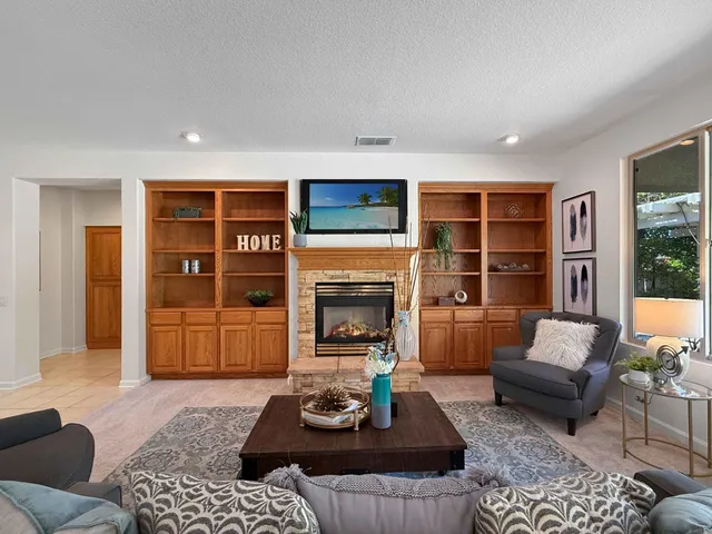 a living room with furniture and a fireplace