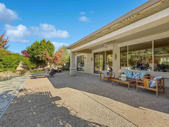 a view of a backyard with chairs