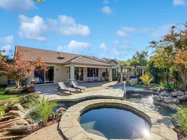 a view of a patio with a table and chairs under an umbrella