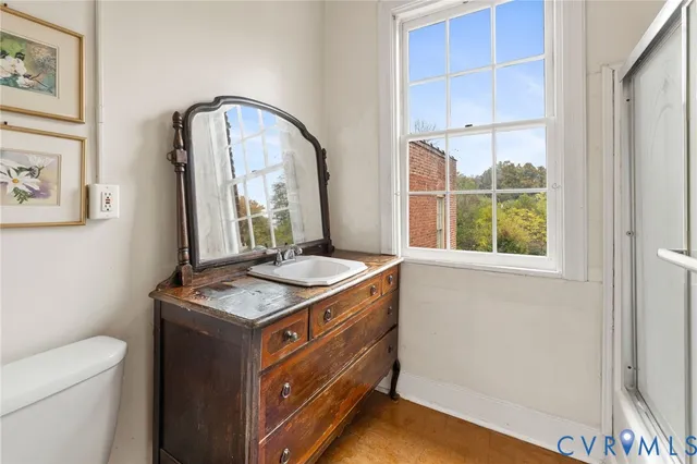 a view of a bedroom with baby bed and window