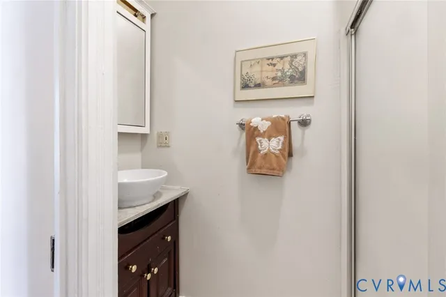 a bedroom with a bed table and chair