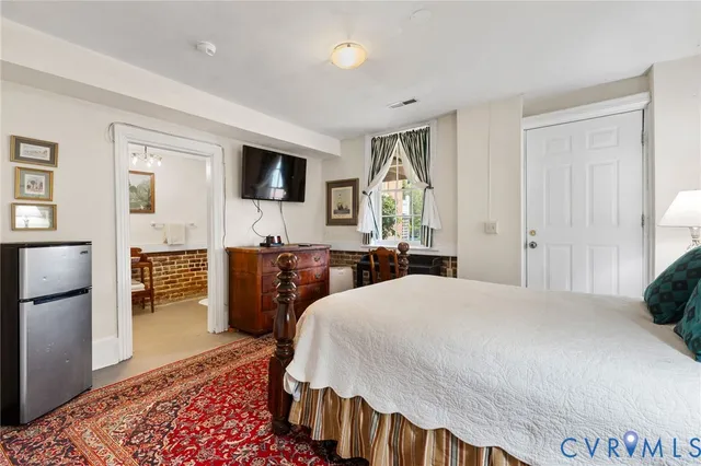 a utility room with a sink a mirror and a fan
