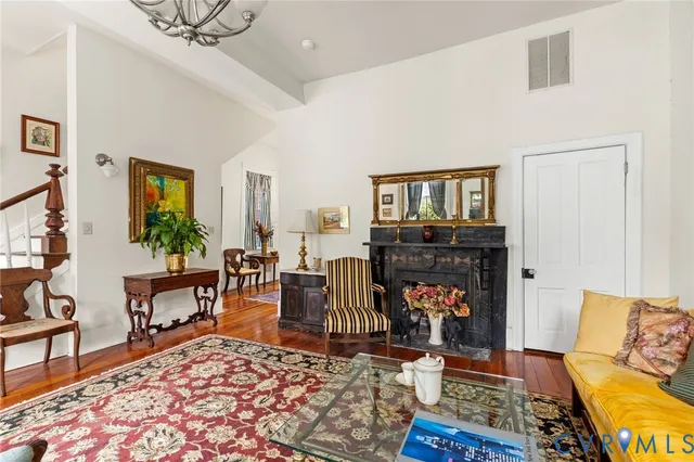 a living room with furniture a rug and a fireplace