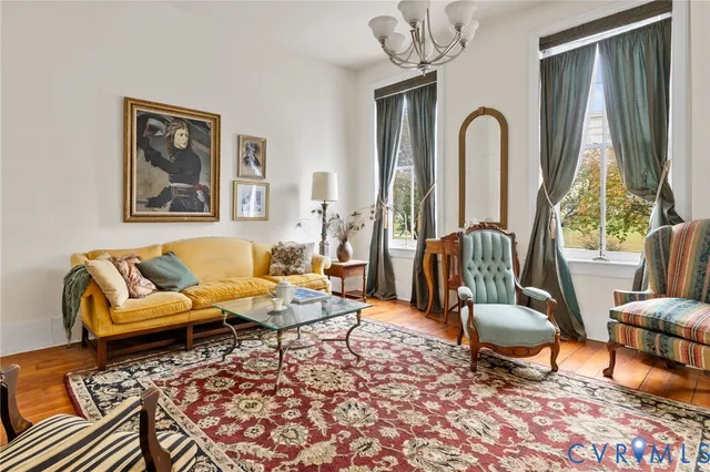 a living room with furniture a rug and a large window