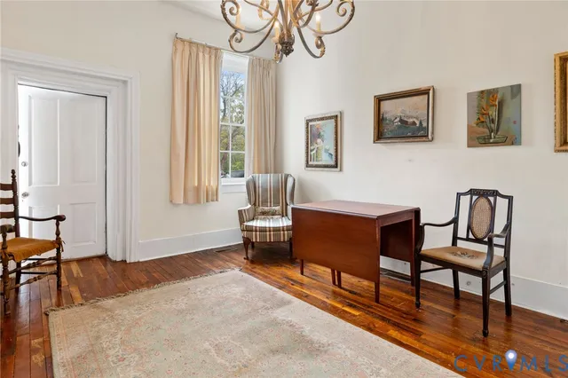 a living room with furniture wooden floor and a window