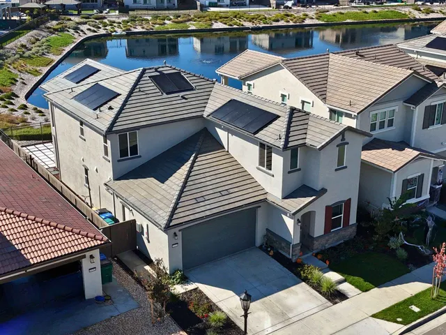 an aerial view of a house with pool table and chairs