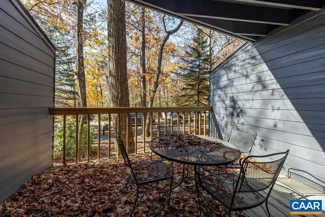 a view of balcony with wooden floor and outdoor seating