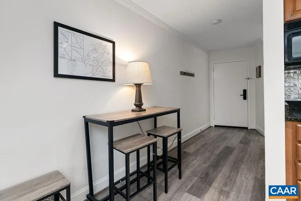 a view of a workspace room with wooden floor and table