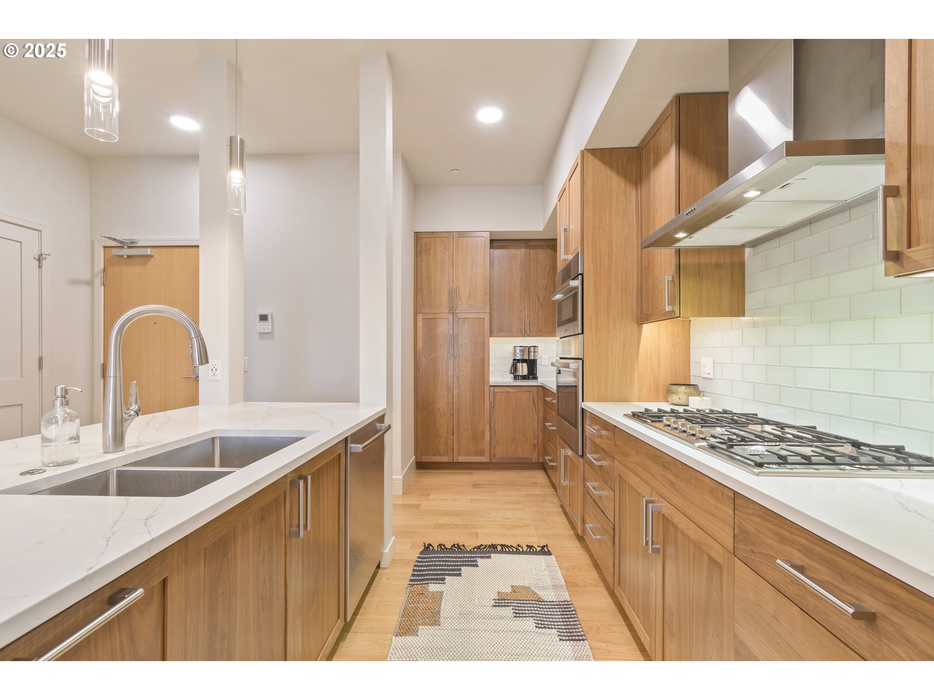 1600 Pearl Street, Unit 305 Eugene, OR 97401 - Photo 11 of 46 a kitchen with granite countertop a sink stove and cabinets