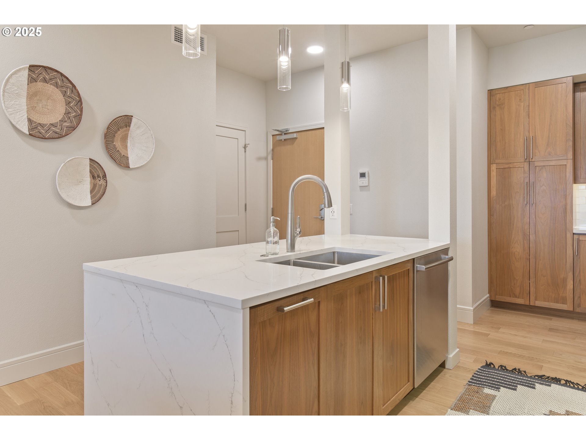 1600 Pearl Street, Unit 305 Eugene, OR 97401 - Photo 12 of 46 a kitchen with a sink and a refrigerator