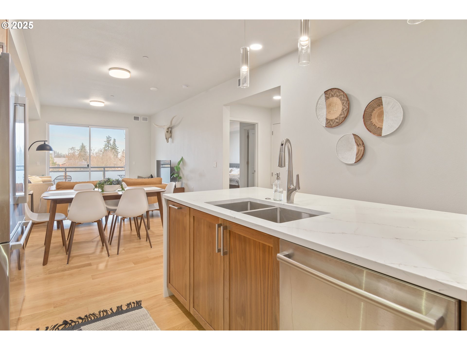 1600 Pearl Street, Unit 305 Eugene, OR 97401 - Photo 14 of 46 a kitchen with a dining table chairs and white cabinets