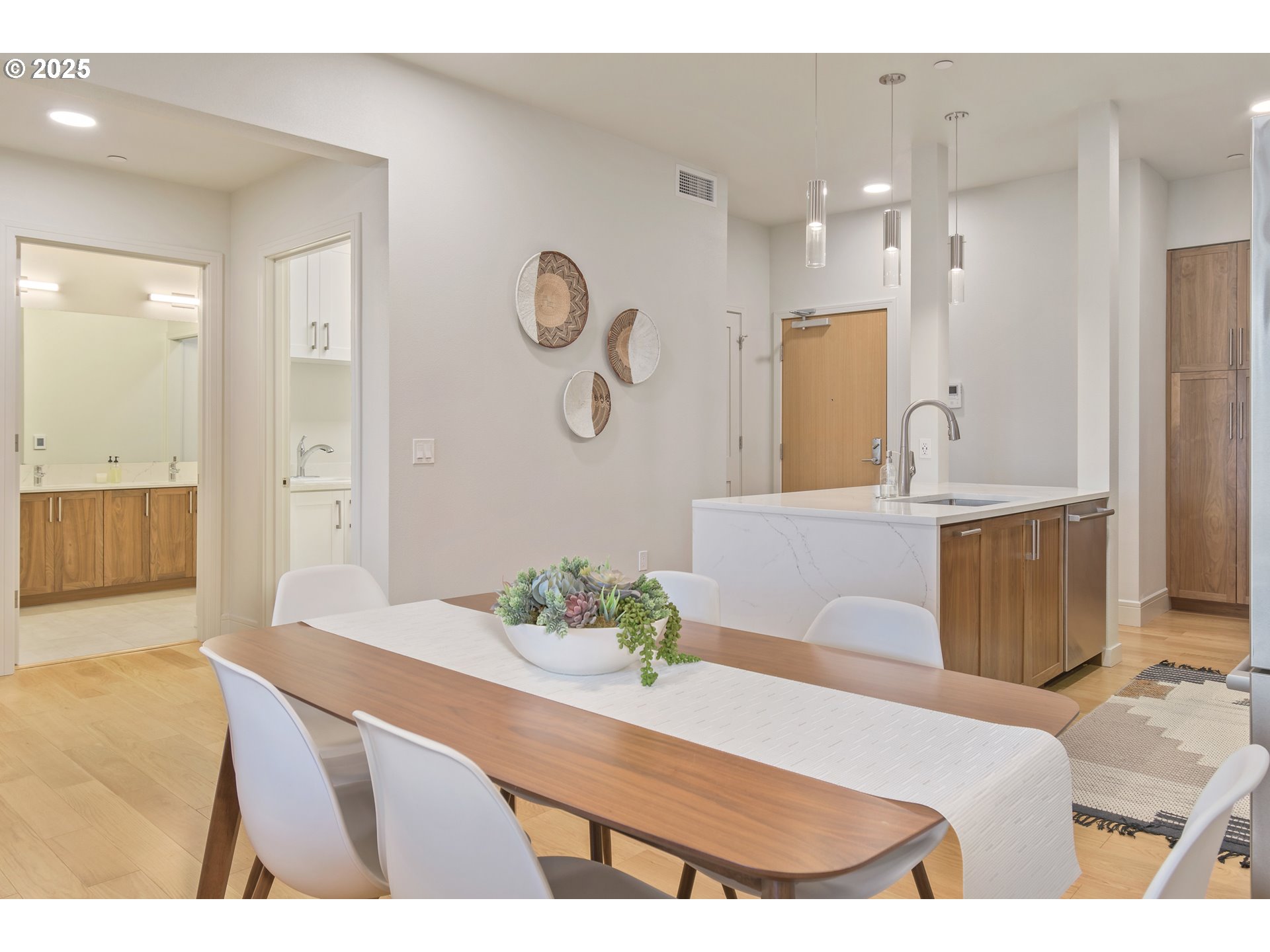1600 Pearl Street, Unit 305 Eugene, OR 97401 - Photo 17 of 46 a bedroom with a bed and a chandelier