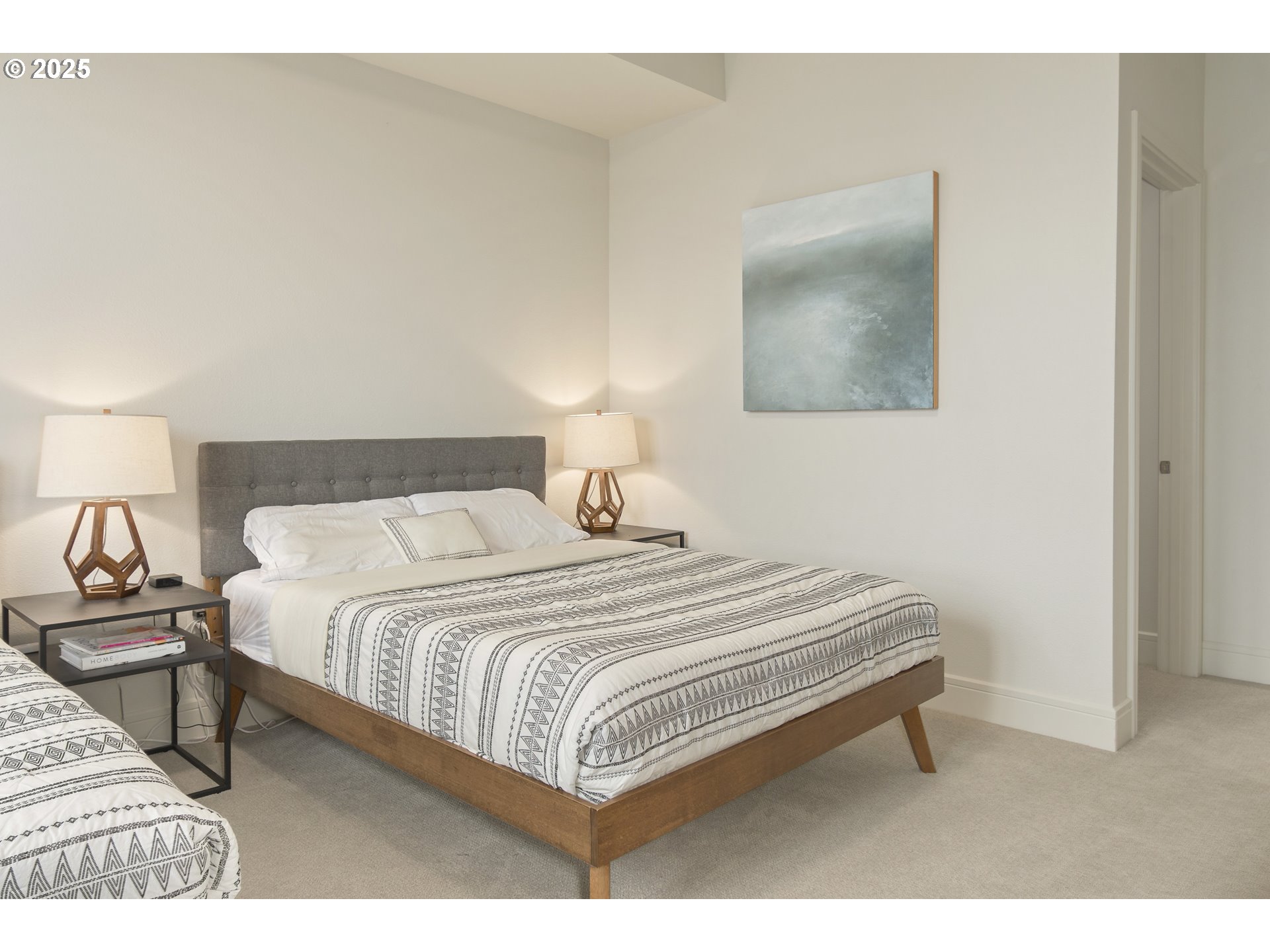 1600 Pearl Street, Unit 305 Eugene, OR 97401 - Photo 24 of 46 a bedroom with a bed and a lamp with wall painting