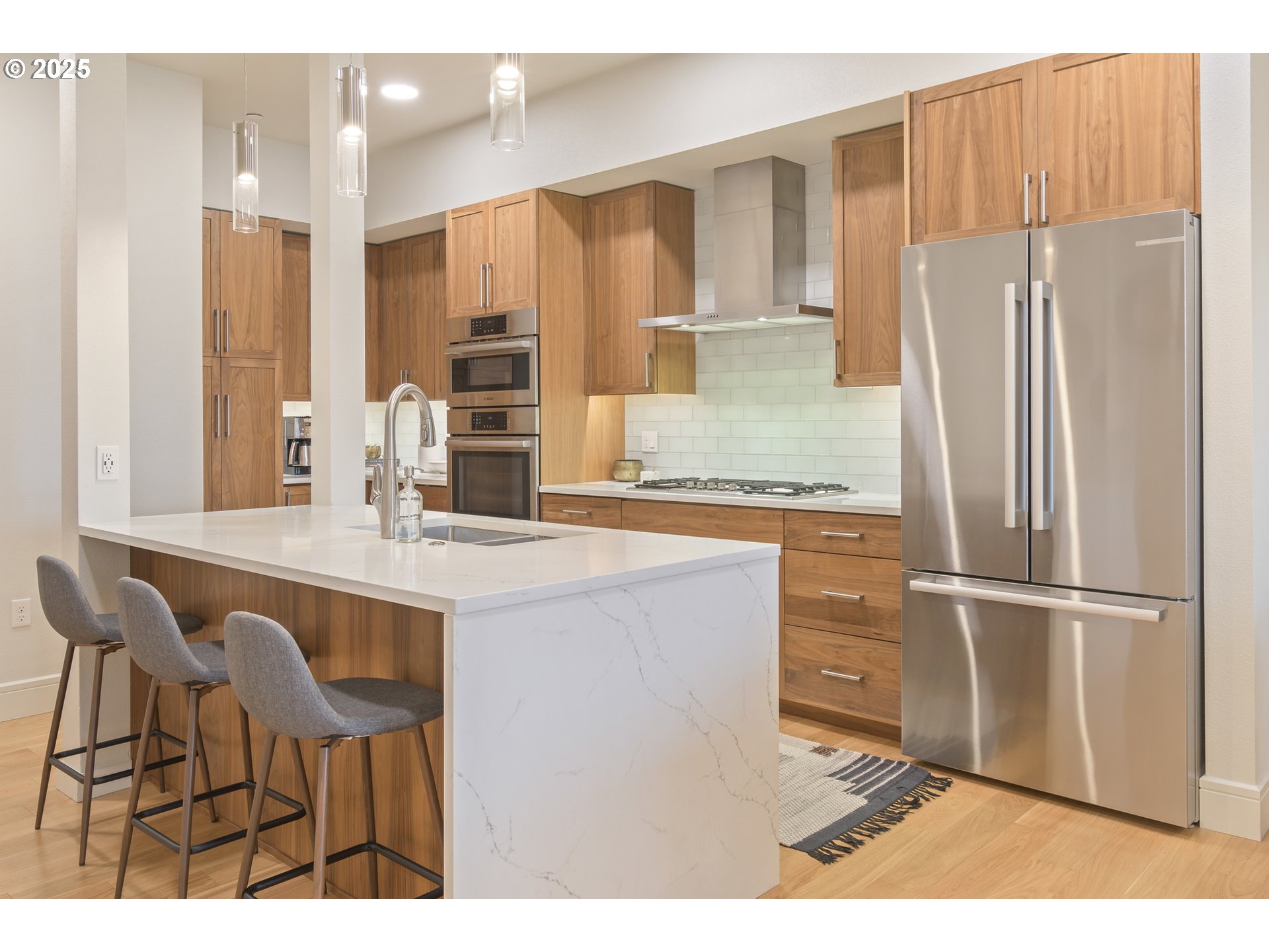 1600 Pearl Street, Unit 305 Eugene, OR 97401 - Photo 8 of 46 a kitchen with kitchen island granite countertop a refrigerator stove microwave and sink
