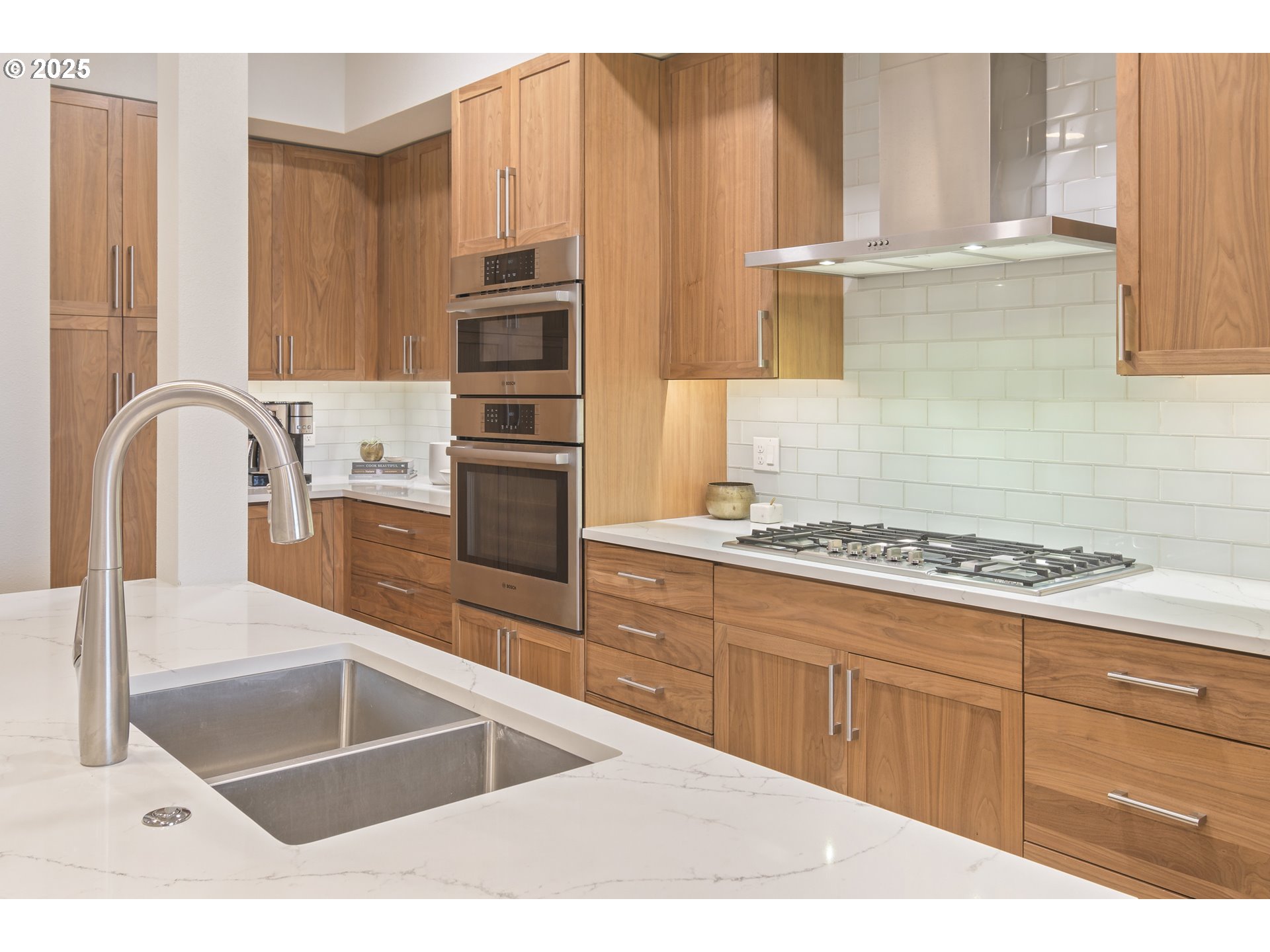 1600 Pearl Street, Unit 305 Eugene, OR 97401 - Photo 10 of 46 a kitchen with stainless steel appliances kitchen island granite countertop a stove a sink and a microwave