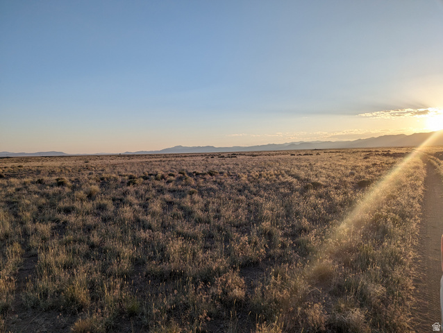 265 South 700 East Beryl, UT 84714 - Photo 3 of 10 Yard at dusk featuring a mountain view
