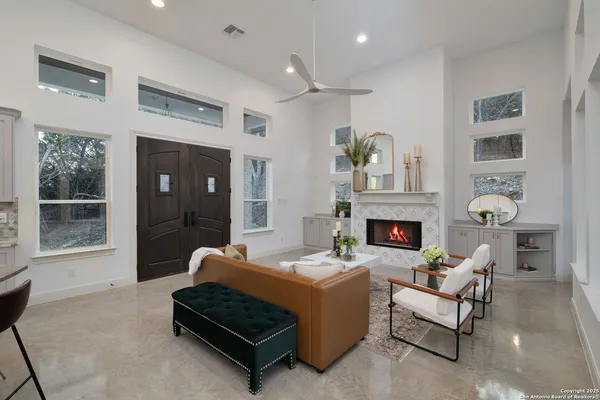a living room with lots of furniture and kitchen view