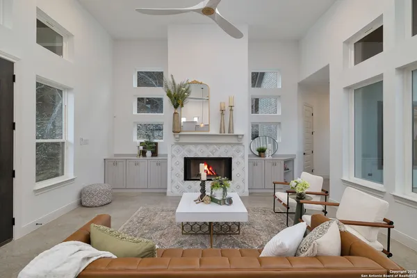 a living room with furniture and view of kitchen
