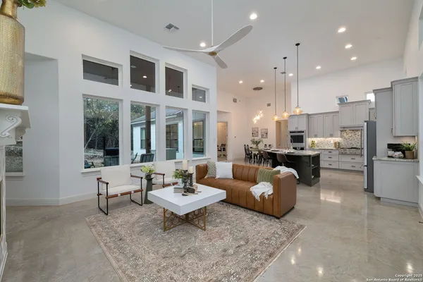 a kitchen with stainless steel appliances kitchen island granite countertop a dining table and chairs