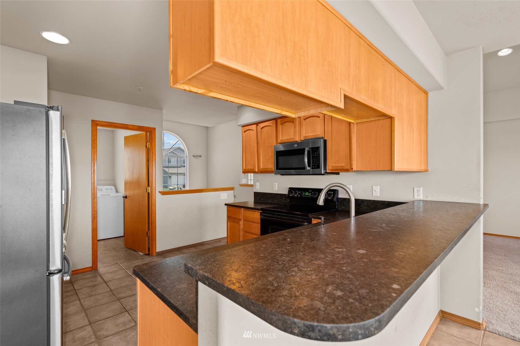 2448 Harvester Loop East Wenatchee, WA 98802 - Photo 13 of 28 a kitchen with a sink a counter top space cabinets and appliances