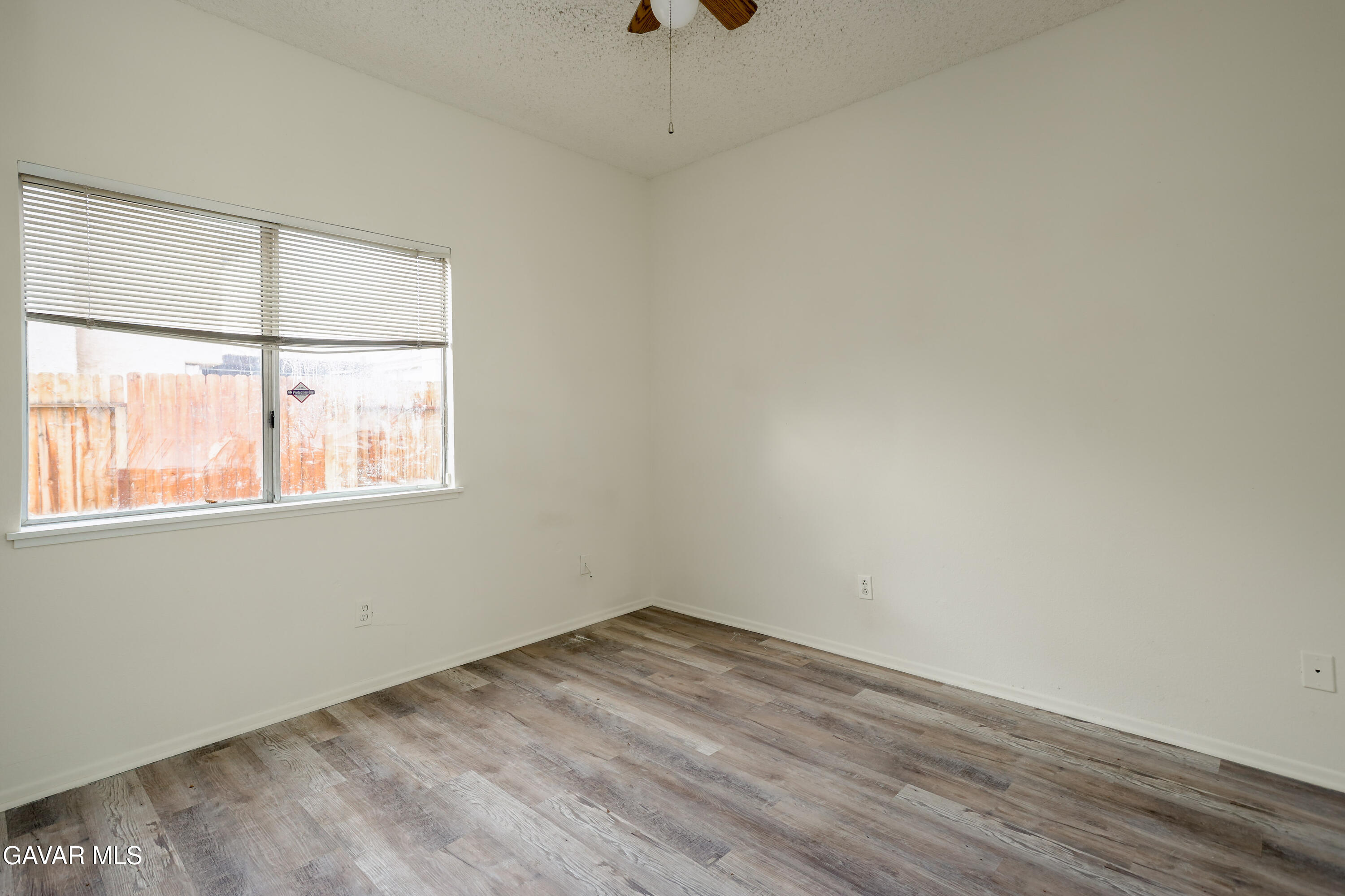 5217 East Ave R 4 Palmdale, CA 93552 - Photo 13 of 33 wooden floor in an empty room with a window