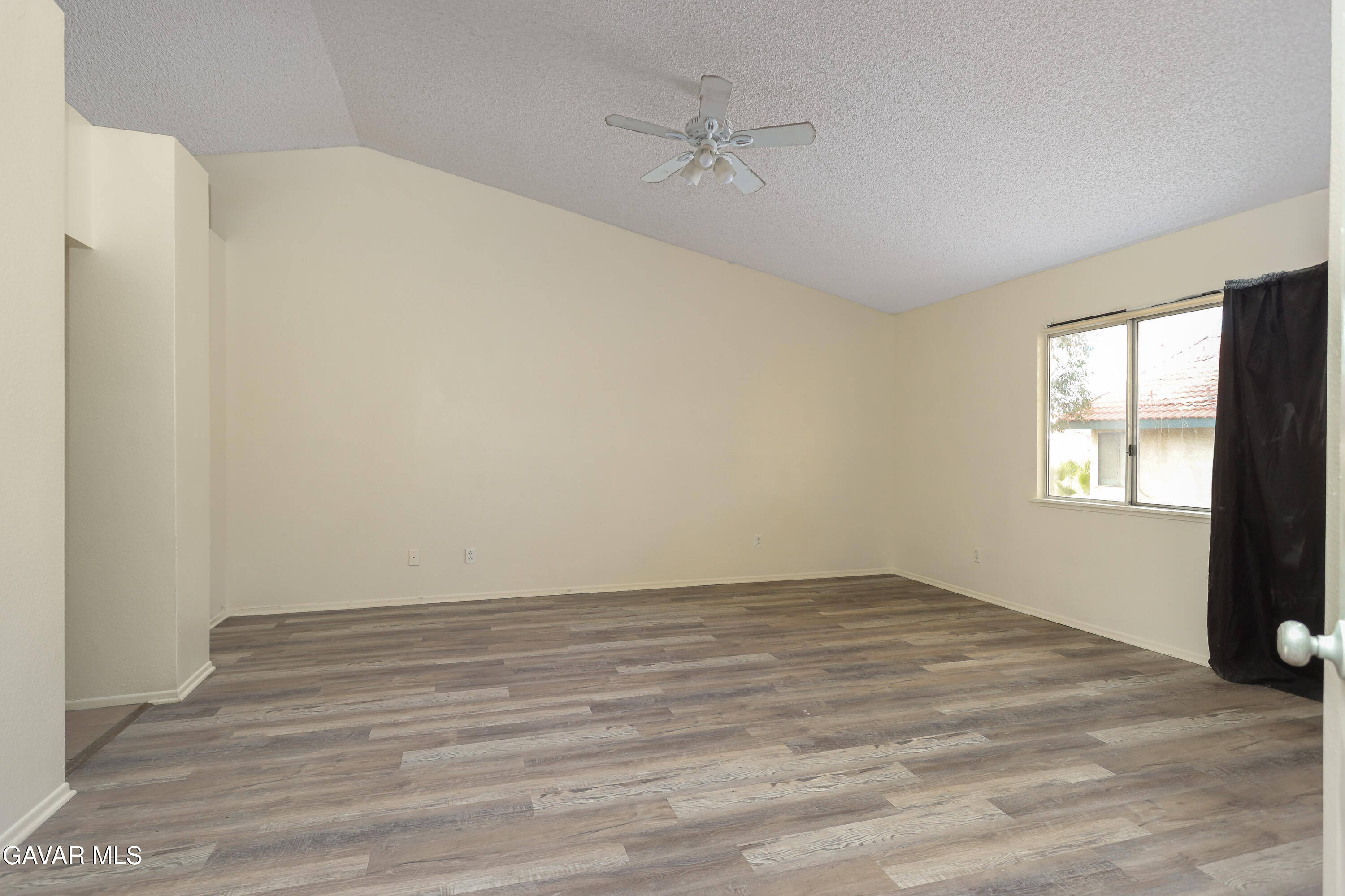 5217 East Ave R 4 Palmdale, CA 93552 - Photo 16 of 33 wooden floor in an empty room with a window