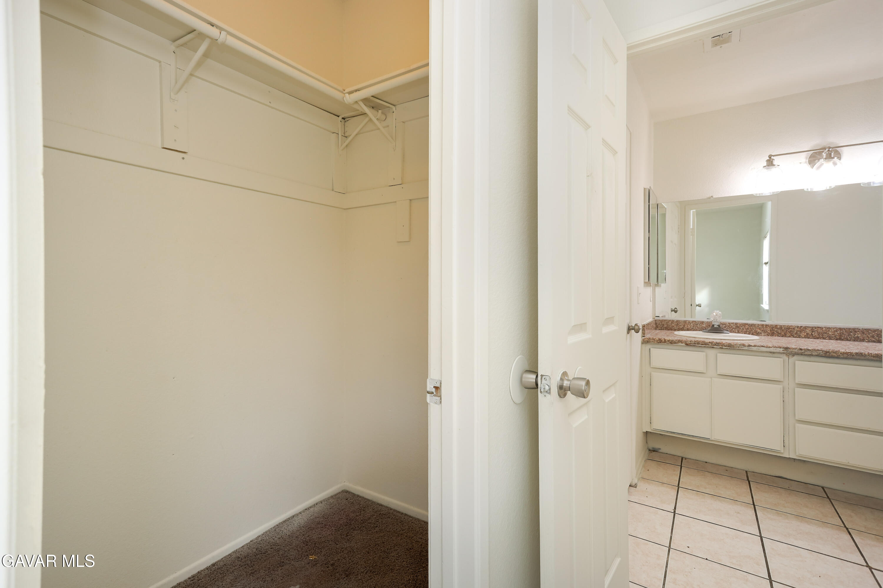 5217 East Ave R 4 Palmdale, CA 93552 - Photo 18 of 33 a bathroom with a granite countertop sink and a mirror