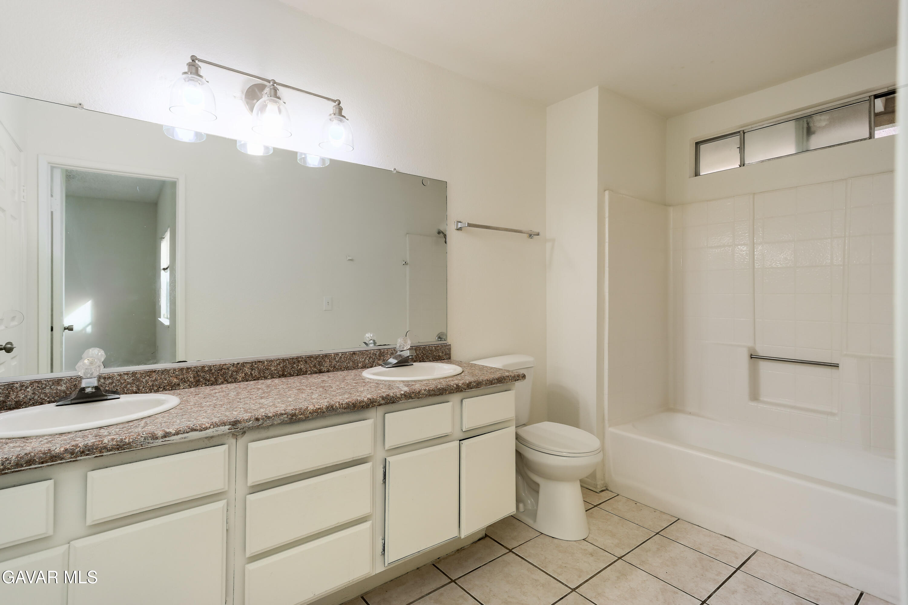 5217 East Ave R 4 Palmdale, CA 93552 - Photo 19 of 33 a bathroom with a granite countertop sink toilet and shower