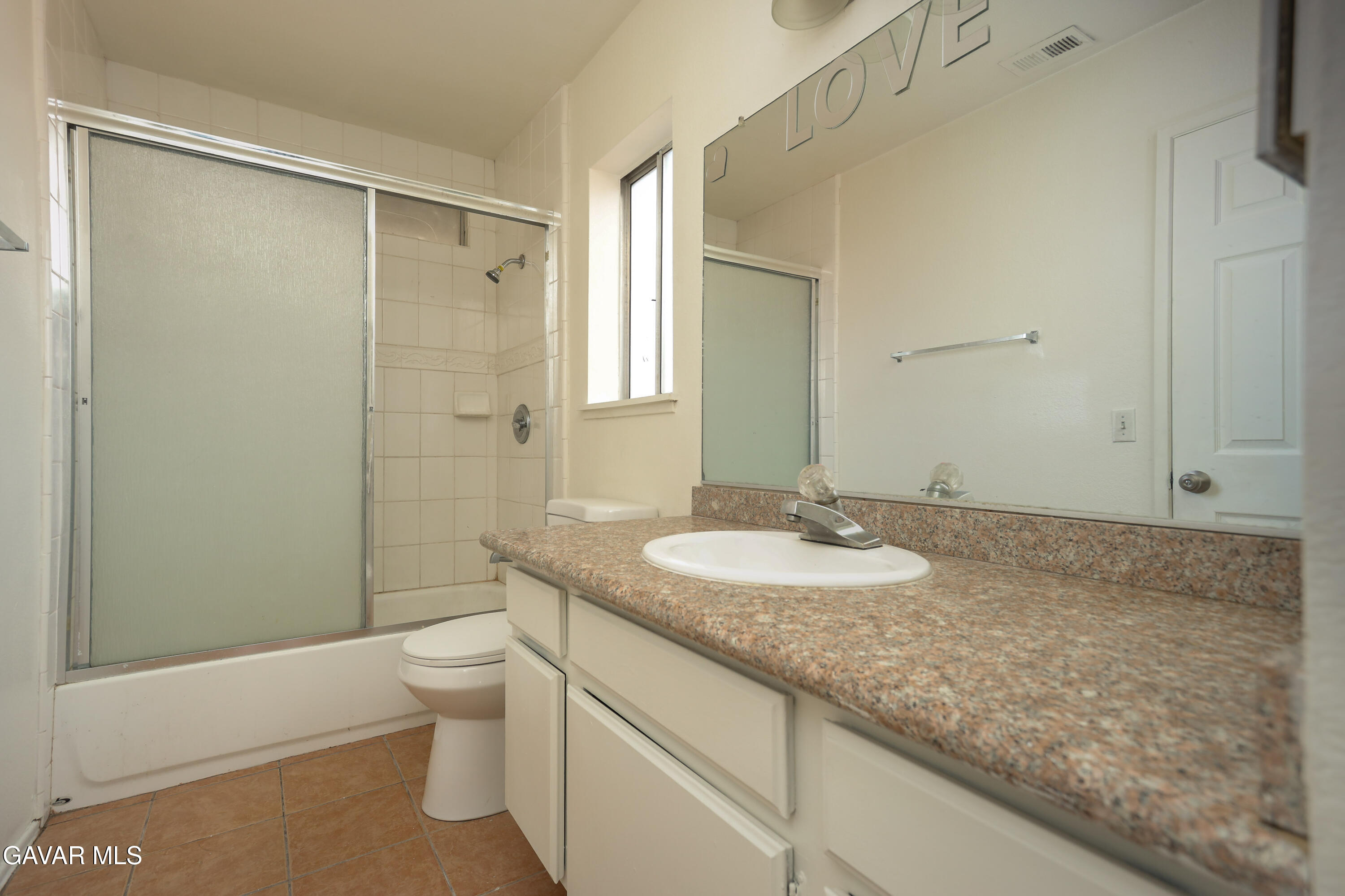 5217 East Ave R 4 Palmdale, CA 93552 - Photo 20 of 33 a bathroom with a granite countertop sink toilet and shower