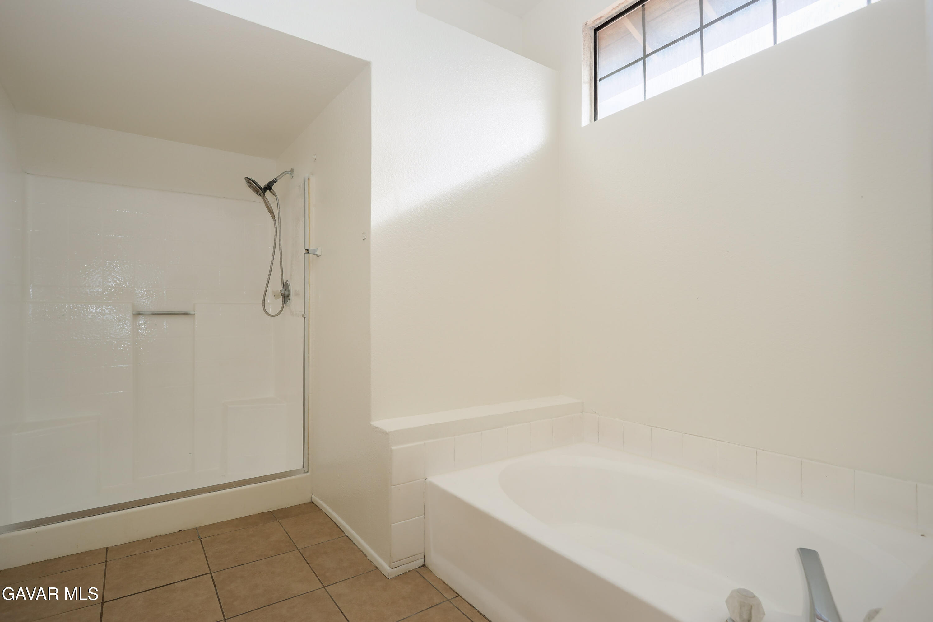 5217 East Ave R 4 Palmdale, CA 93552 - Photo 23 of 33 a bathroom with a bathtub