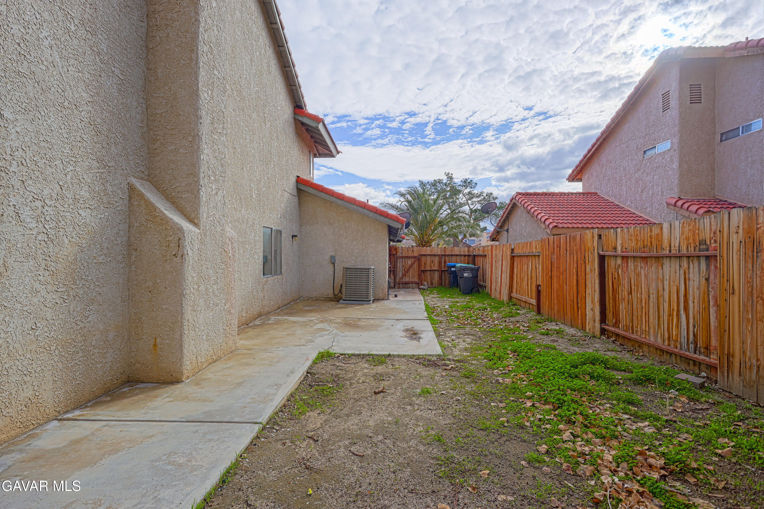 5217 East Ave R 4 Palmdale, CA 93552 - Photo 27 of 33 a view of a backyard with wooden fence