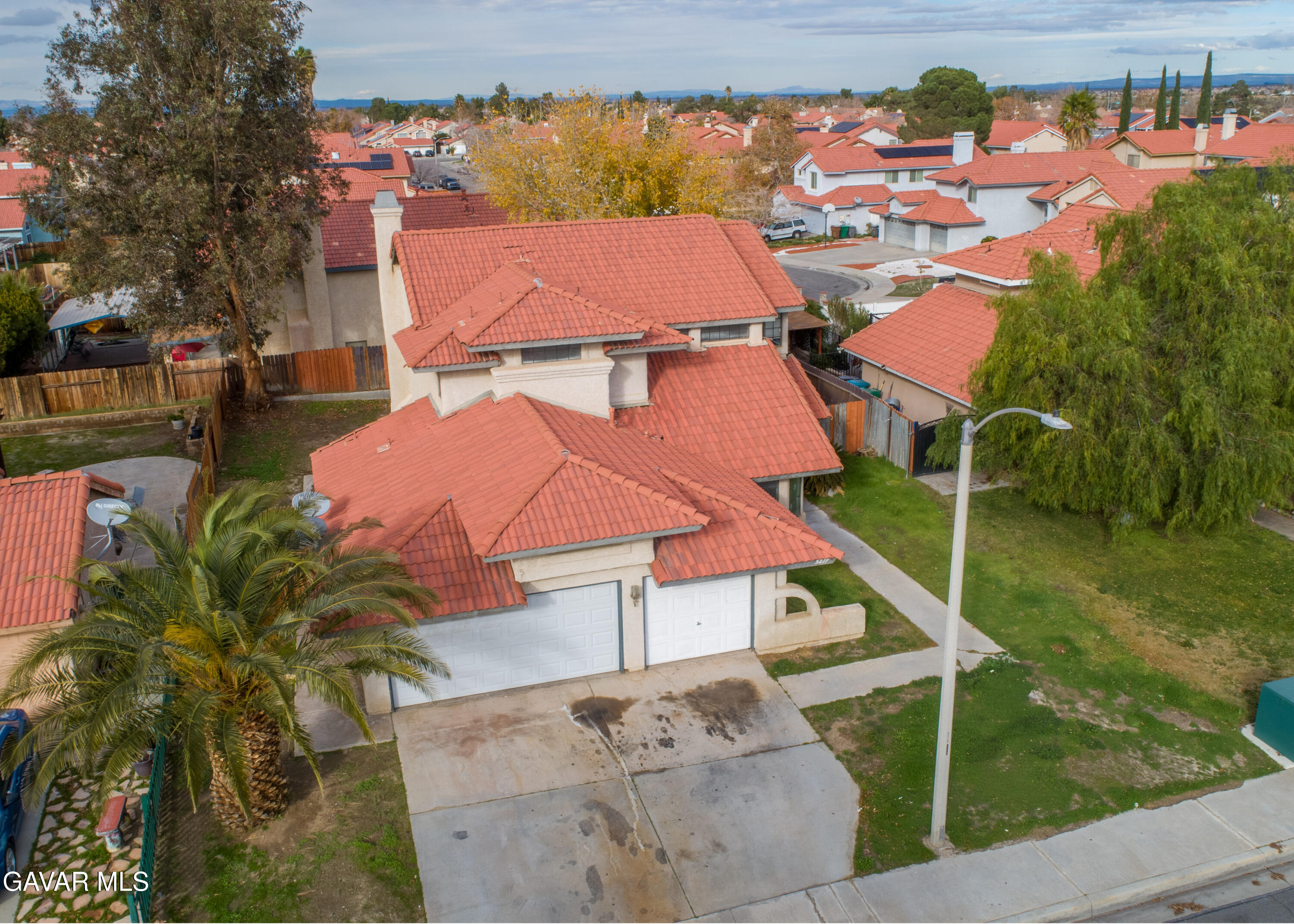5217 East Ave R 4 Palmdale, CA 93552 - Photo 30 of 33 an aerial view of residential houses with outdoor space and trees