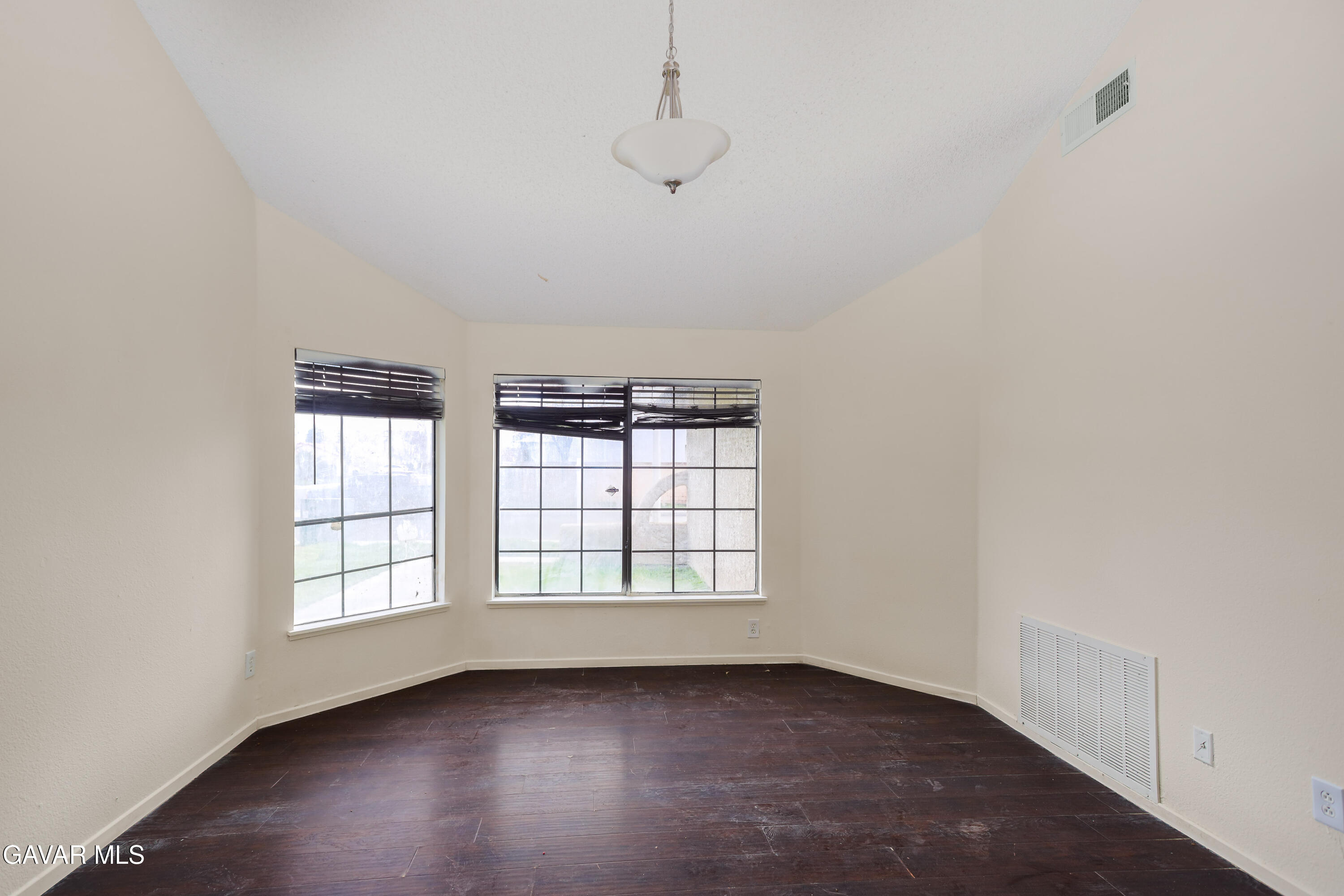 5217 East Ave R 4 Palmdale, CA 93552 - Photo 3 of 33 an empty room with wooden floor and windows