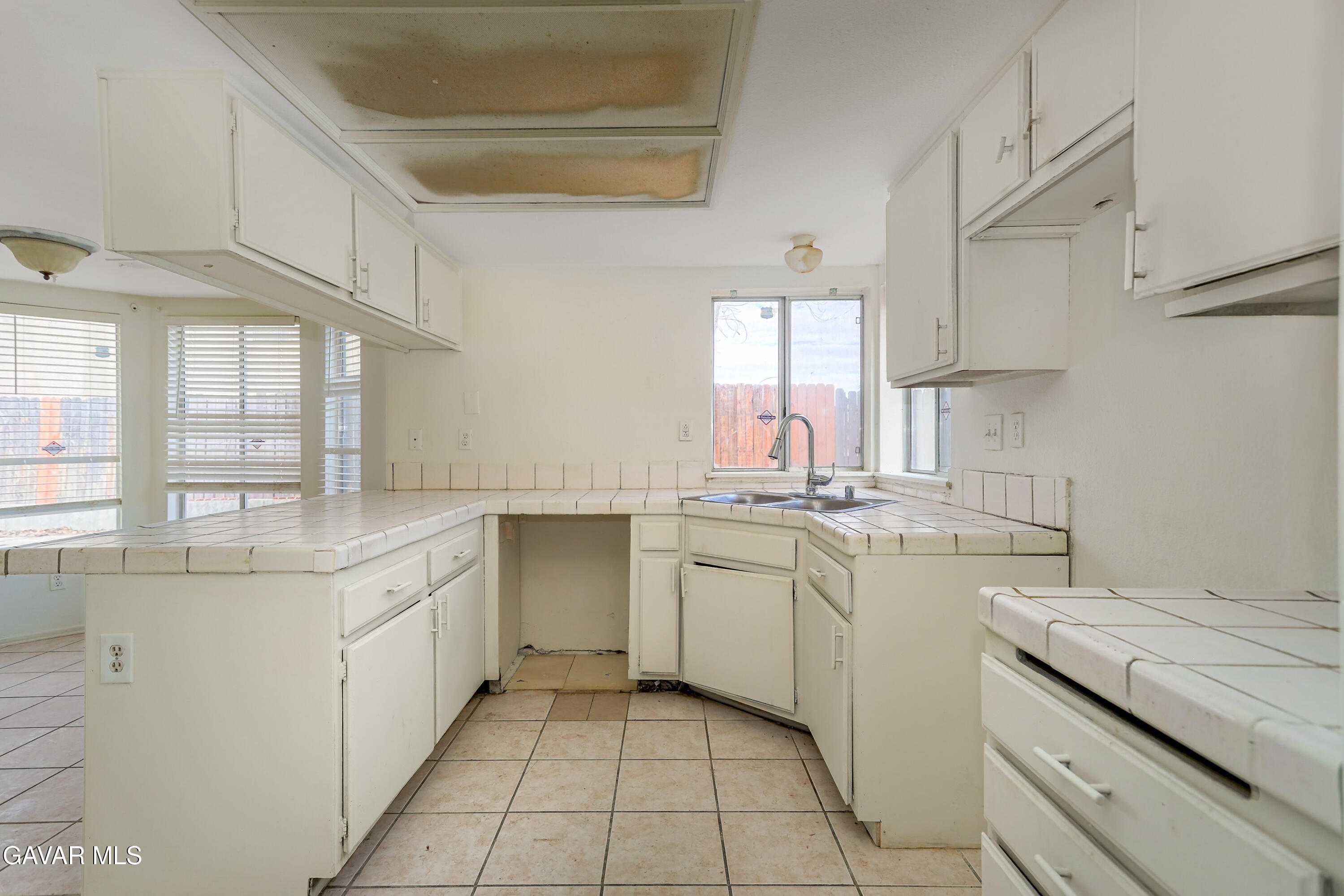 5217 East Ave R 4 Palmdale, CA 93552 - Photo 5 of 33 a kitchen with sink cabinets and window
