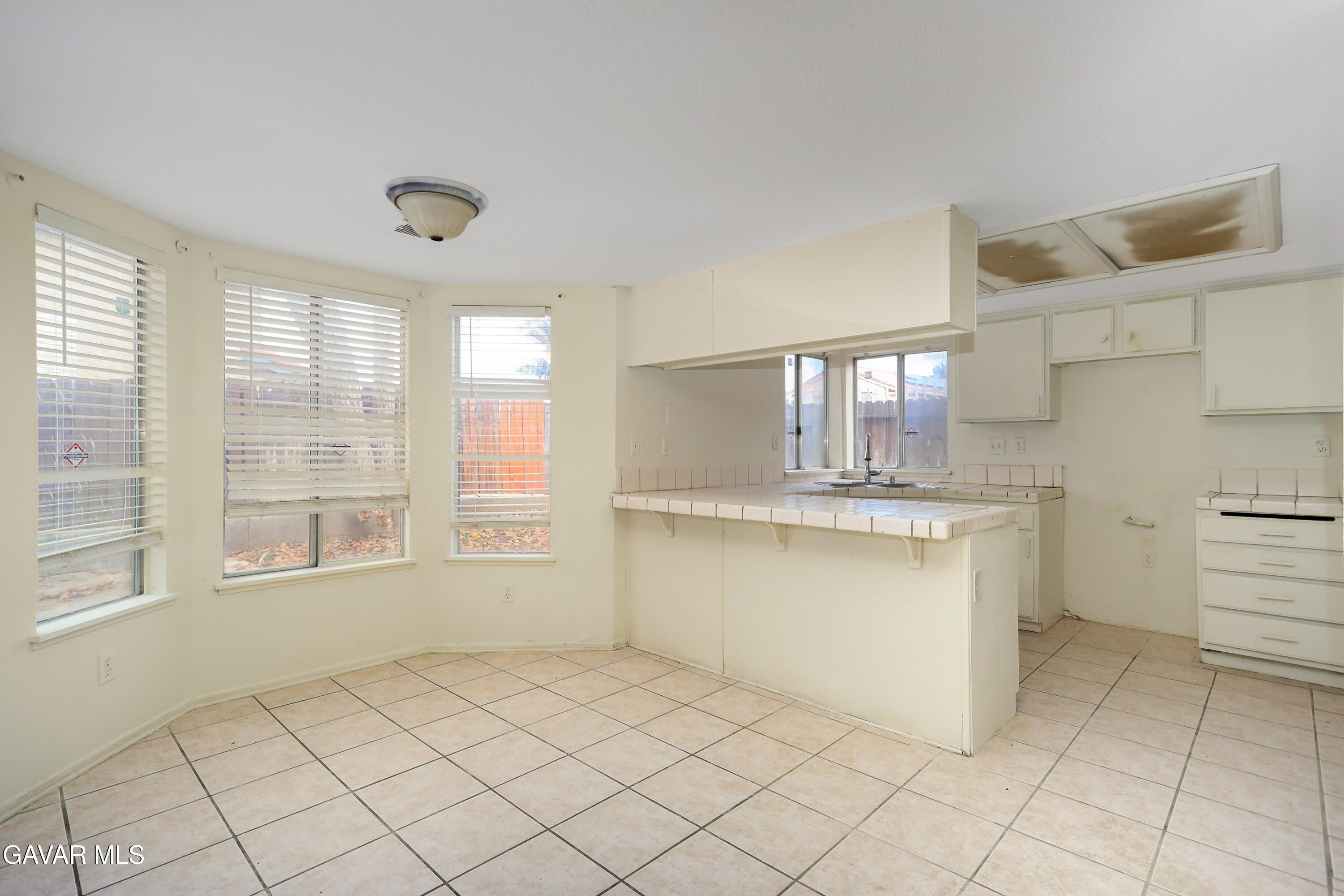 5217 East Ave R 4 Palmdale, CA 93552 - Photo 8 of 33 a kitchen with a stove a sink and a refrigerator
