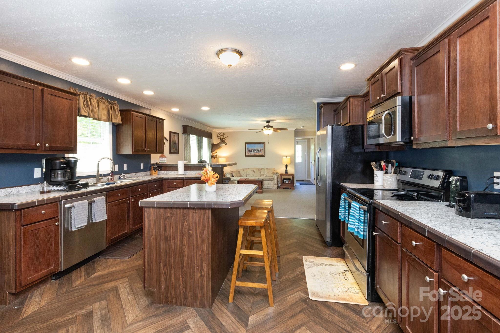 324 Lytle Cove Road Swannanoa, NC 28778 - Photo 11 of 27 a kitchen with stainless steel appliances granite countertop wooden cabinets a sink dishwasher a stove and a refrigerator